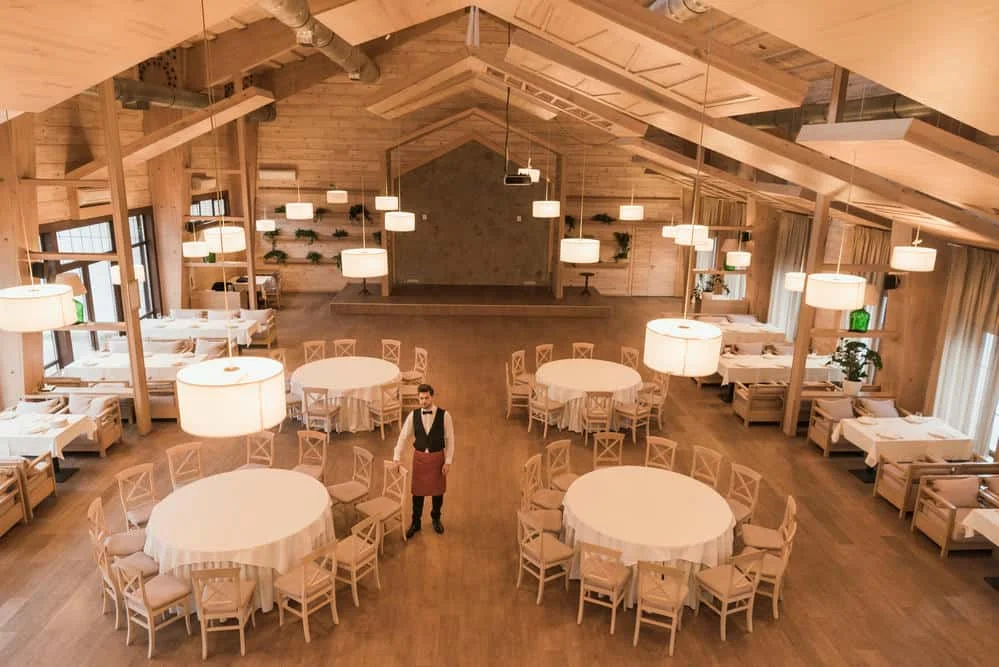 Elegant banquet hall setup with decorated tables and chairs, perfect for weddings and corporate events.